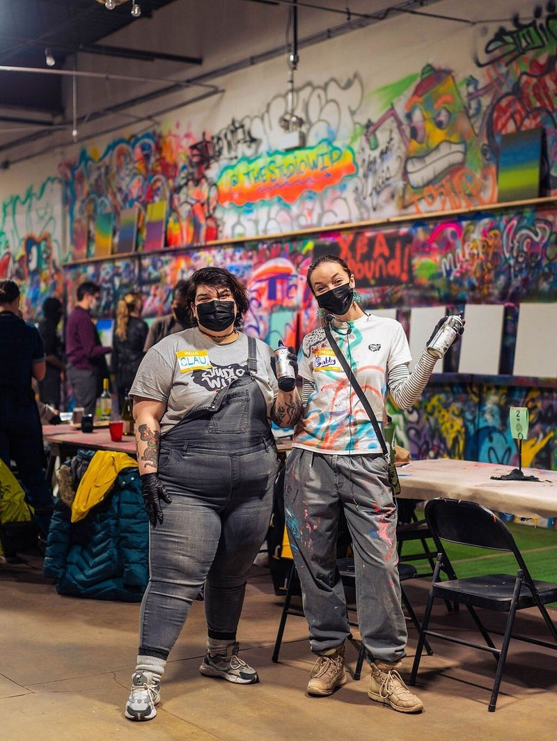 2 people spray painting