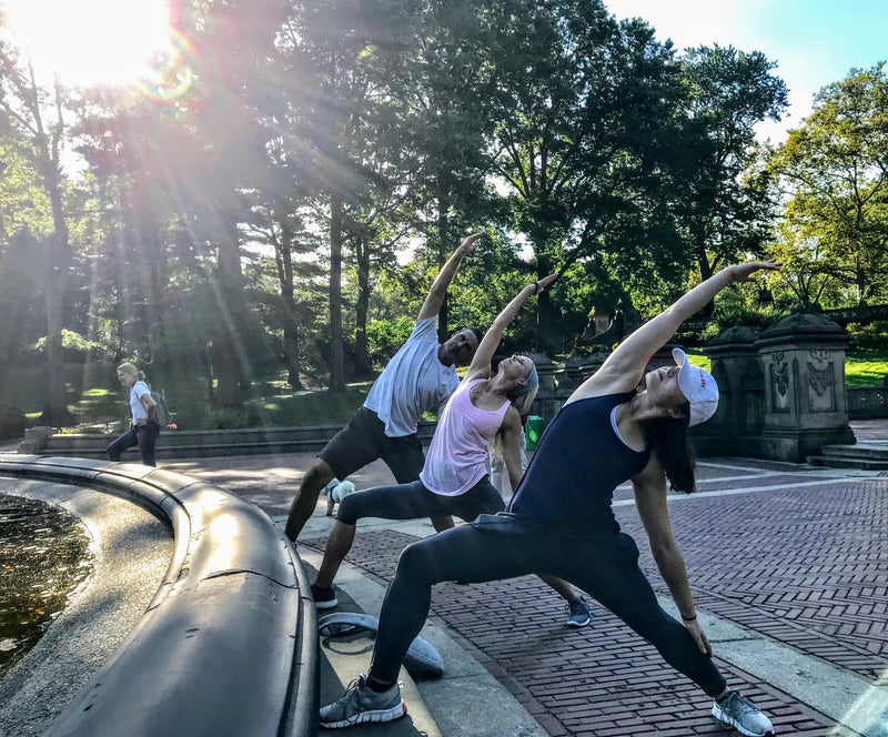 3-people-doing-yoga-pose-in-central-park-jpg