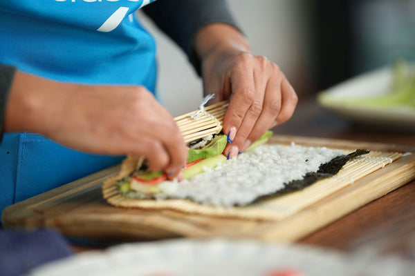 several colorful sushi on a wooden board.jpg