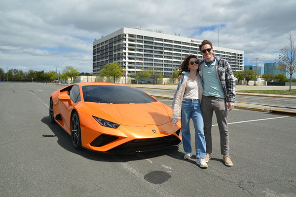 couple and orange cool car