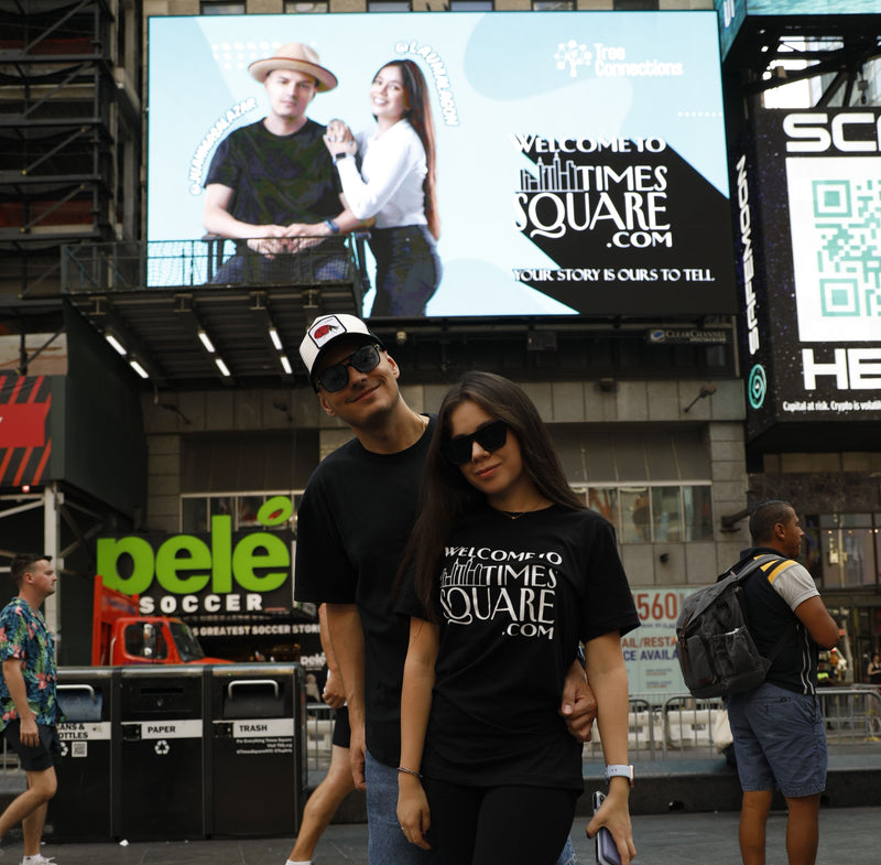 couple-standing-under-welcome-to-times-square-billboard