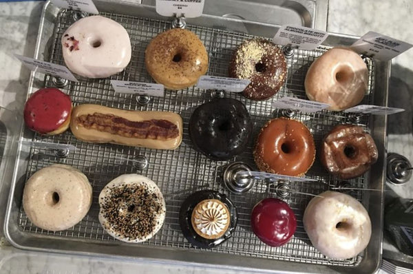woman presenting donuts