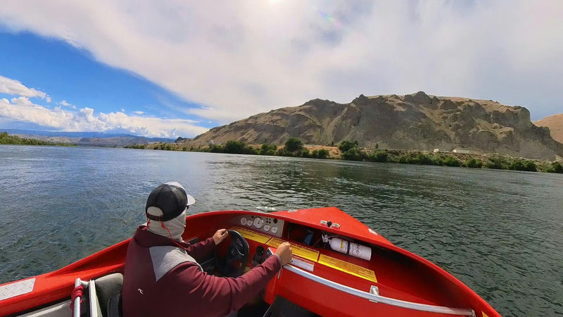 driving red boat with view
