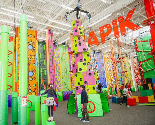 man safely dropping from a climbing wall