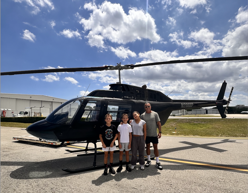 family-in-front-of-helicopter
