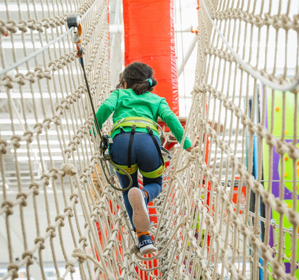 2 girls on a climbing wall