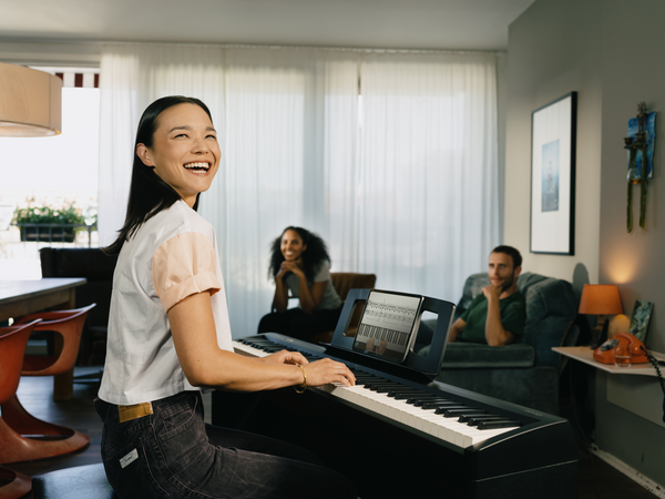 girl performing piano for group