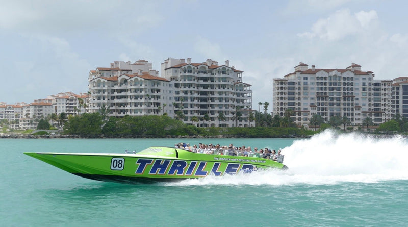 green-speedboat-with-apartment-building-on-shore