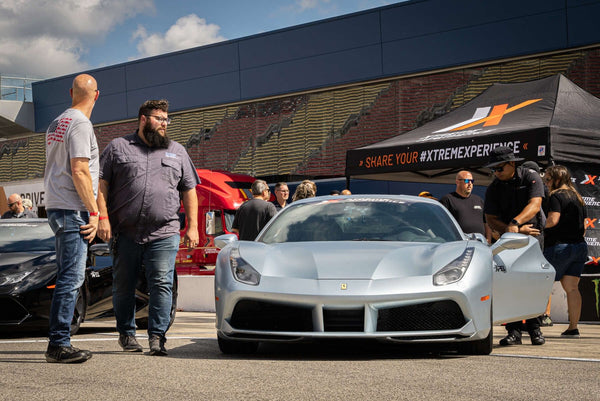 couple with red ferrari