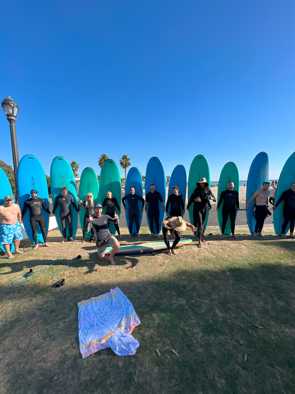 surfers walking beach.jpg