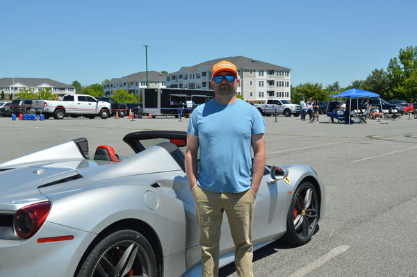 three people with red super car