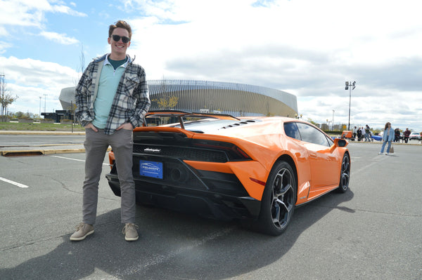 couple and orange cool car