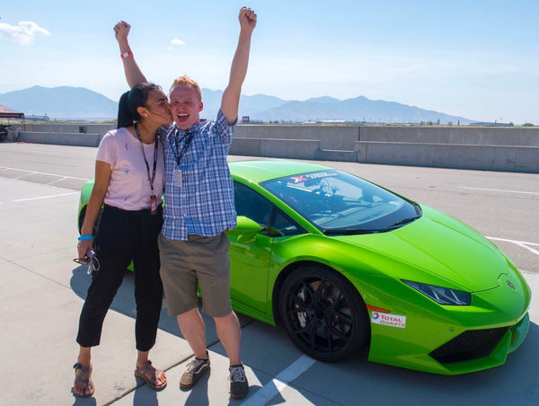 white and black lamborghini with driver and passenger