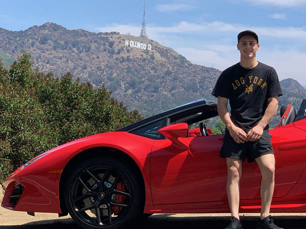 Leaning on lambo with hollywood sign in background