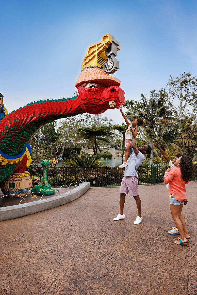 lifting-child-up-to-red-dragon-lego