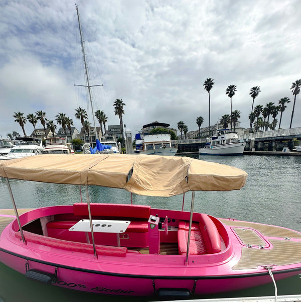 woman driving pink boat.jpg