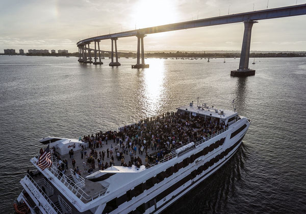 couple toasting in front of the window on san diego premier dinner cruise