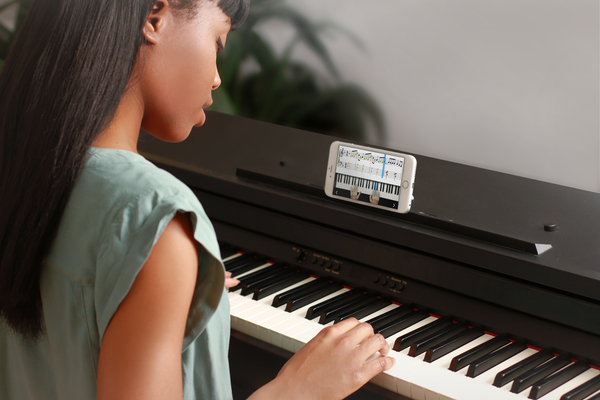 girl performing piano for group