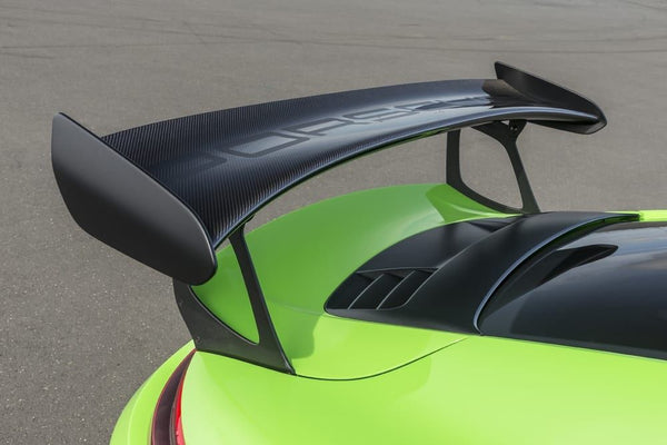 green porsche driving fast