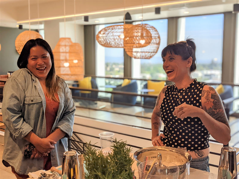 two-women-laughing-with-cocktail-station
