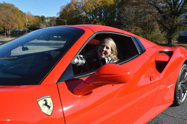 woman in red super car