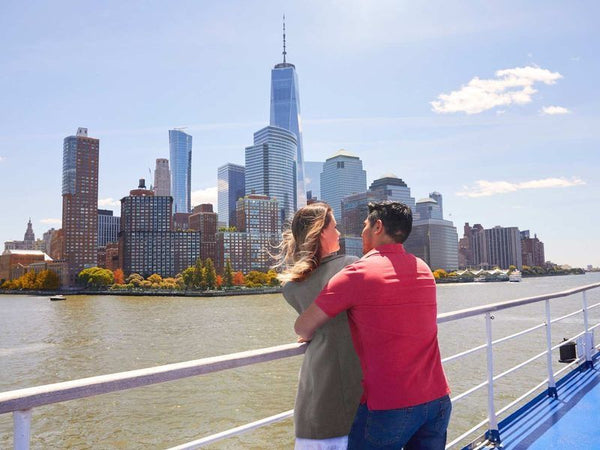 couple on a bout tour looking at the NYC skyline