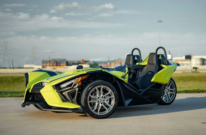 2-day-polaris-slingshot-rental-houston-neon-yellow-side-view-field.webp