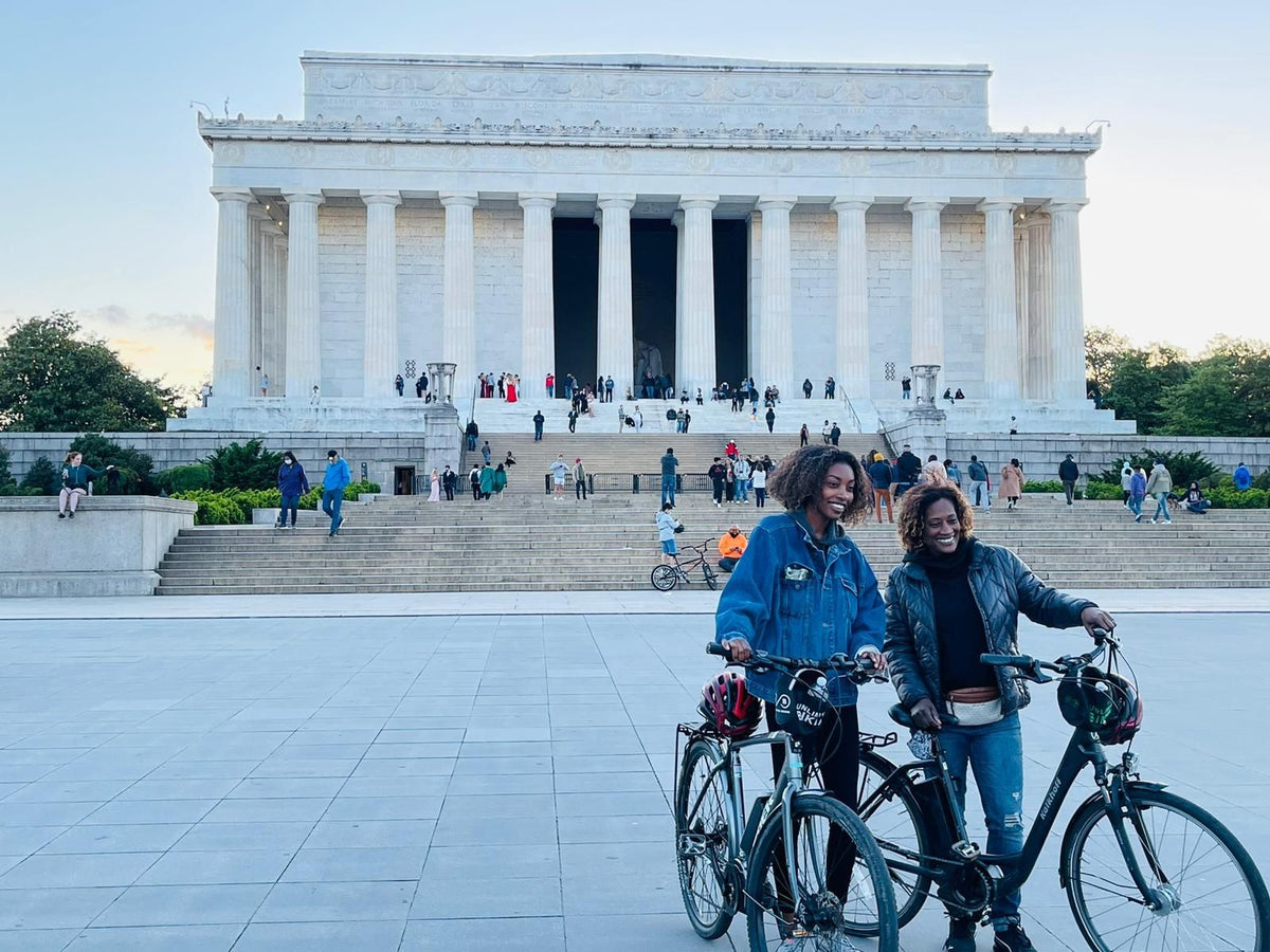 2-people-posing-with-bikes-at-lincoln-memorial-jpg