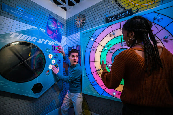 2 people pressing buttons on control board