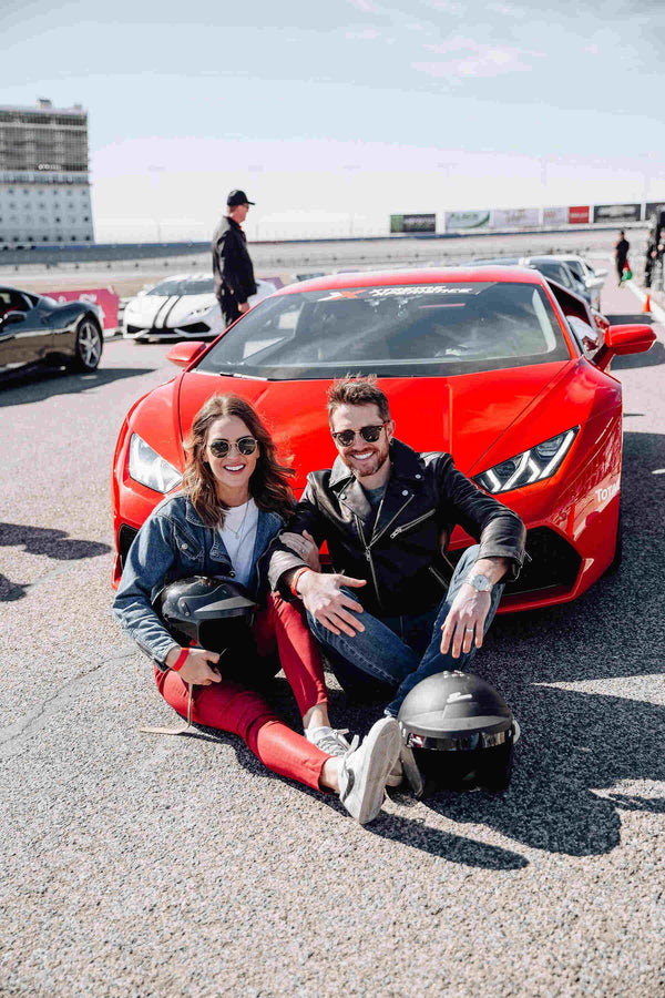 2 people sitting with ferrari