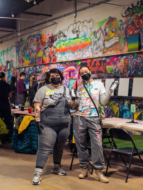 2 people spray painting