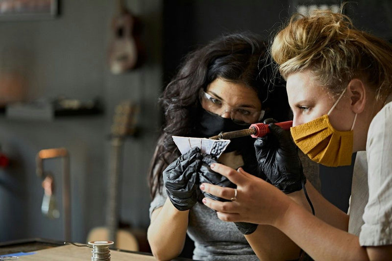 2-people-working-on-glass