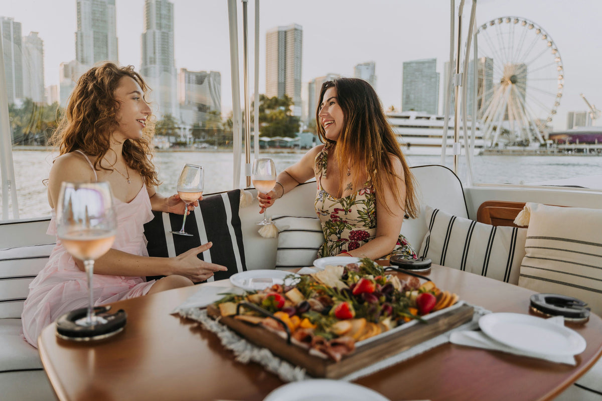 2-women-on-a-boat-with-wine-and-charcuterie