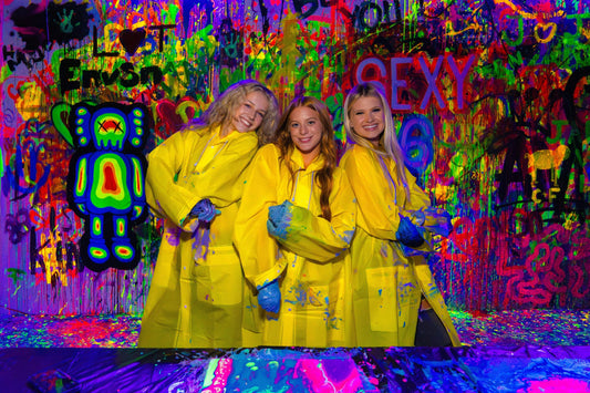 3 girls in neon paint room