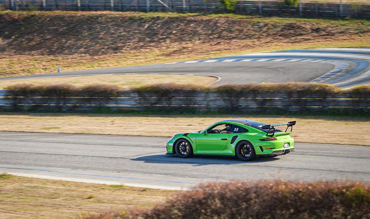 Green Porsche on track