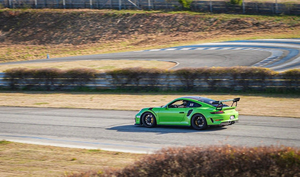 Green supercar on track