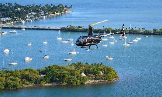 Helicopter flying over land and water with boats