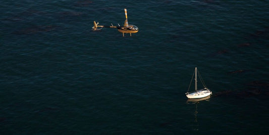 Helicopter in flight over boat