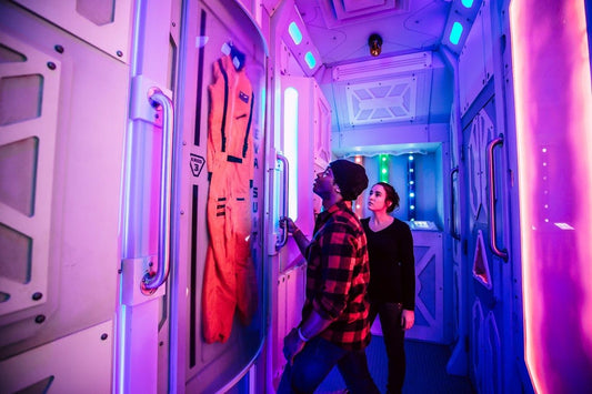 Man and women looking at door in mission to mars escape room