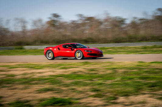 Red Ferrari 296 GTB Speeding on Track