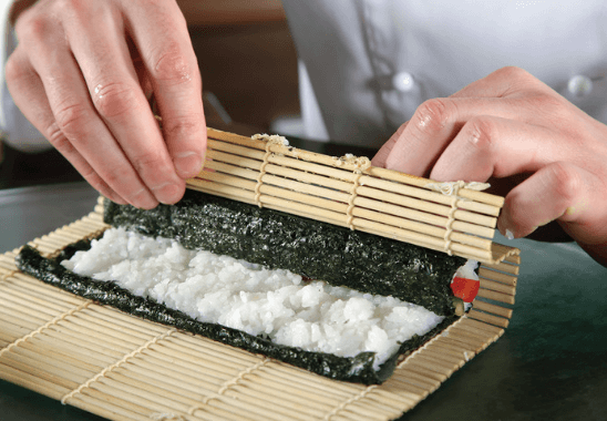 Rice with seaweed on a rolling sheet