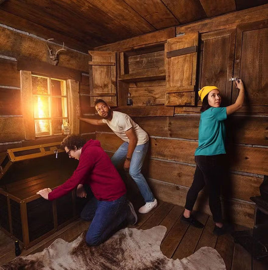 Three individuals inside the cabin, actively exploring for openings to clues