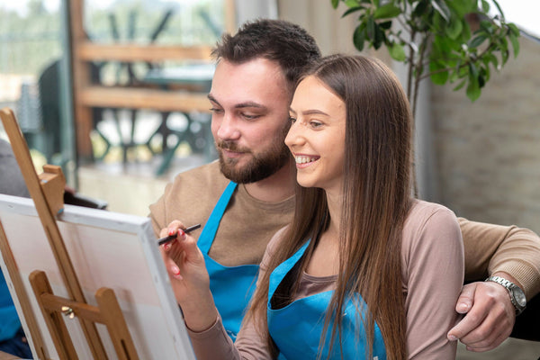 a couple enjoying a paint and sip activity.jpg
