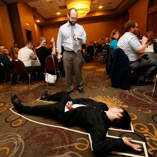 actor in murder mystery dinner on floor