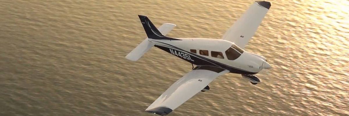 airplane-flying-over-water