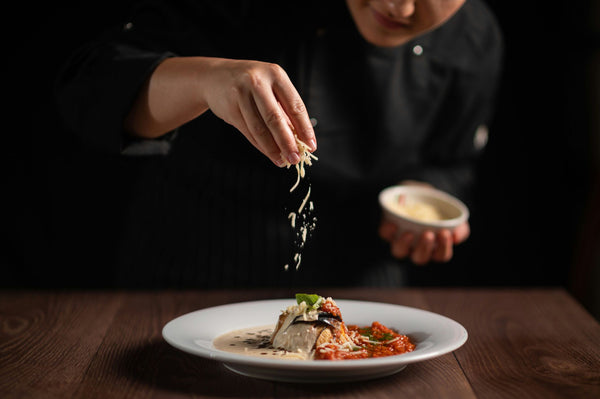 Chef adding cheese to plate.jpg