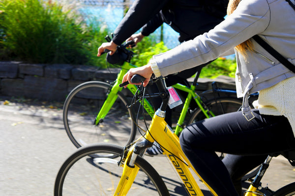 close up on 2 people riding bikes