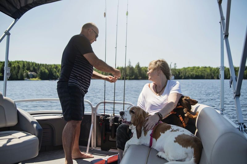 Couple and dog on boat fishing