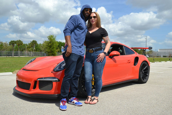 couple and sports car