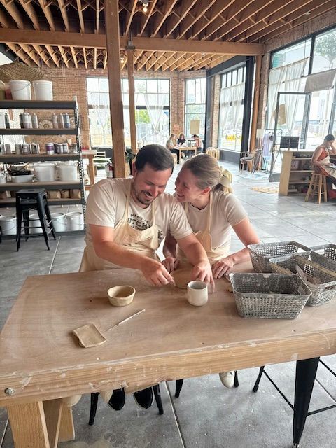 couple doing pottery together